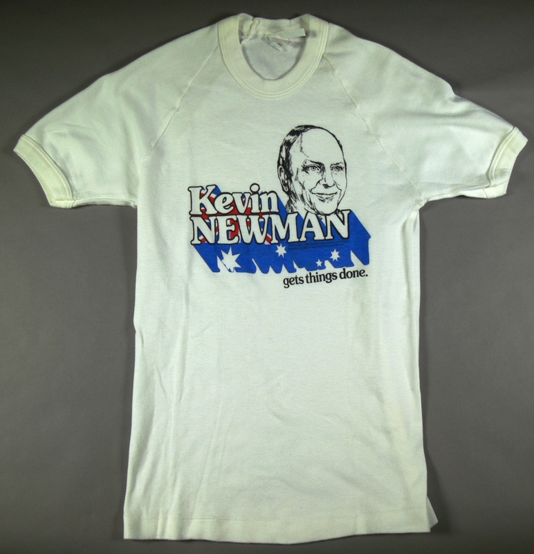 A white t-shirt with a caricature of a man's head, and the words 'Kevin Newman gets things done' with lettering shadow in the colours of the Australian flag. A white t-shirt with a caricature of a man's head, and the words 'Kevin Newman gets things done' with lettering shadow in the colours of the Australian flag.