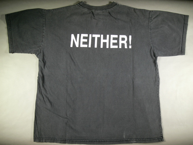 A faded black tshirt with the word 'NEITHER!' printed on the front. A faded black tshirt with the word 'NEITHER!' printed on the front.