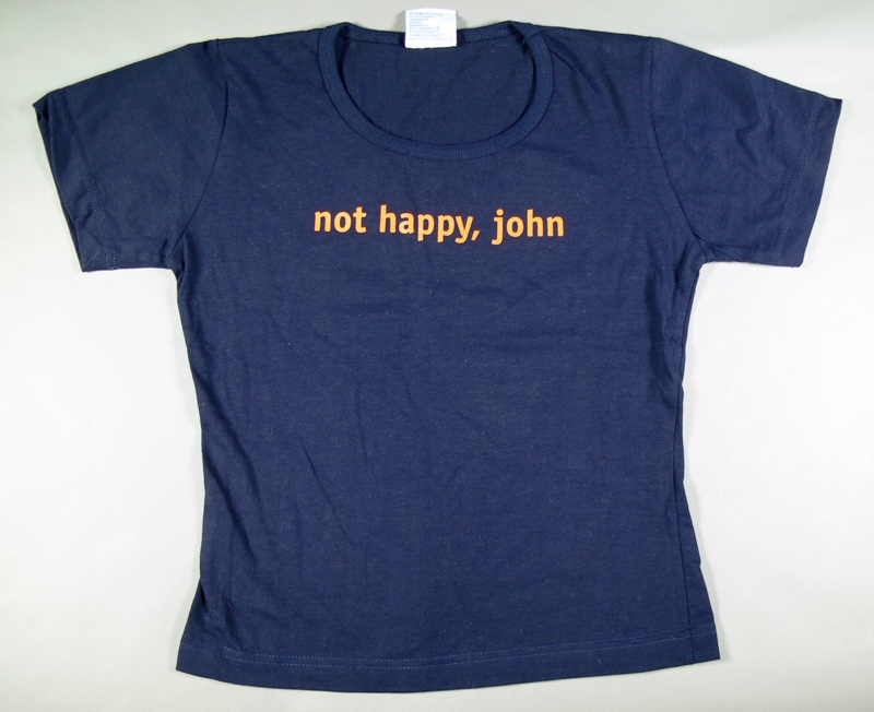 Dark blue t-shirt with the words 'not happy, john' in orange letters. Dark blue t-shirt with the words 'not happy, john' in orange letters.