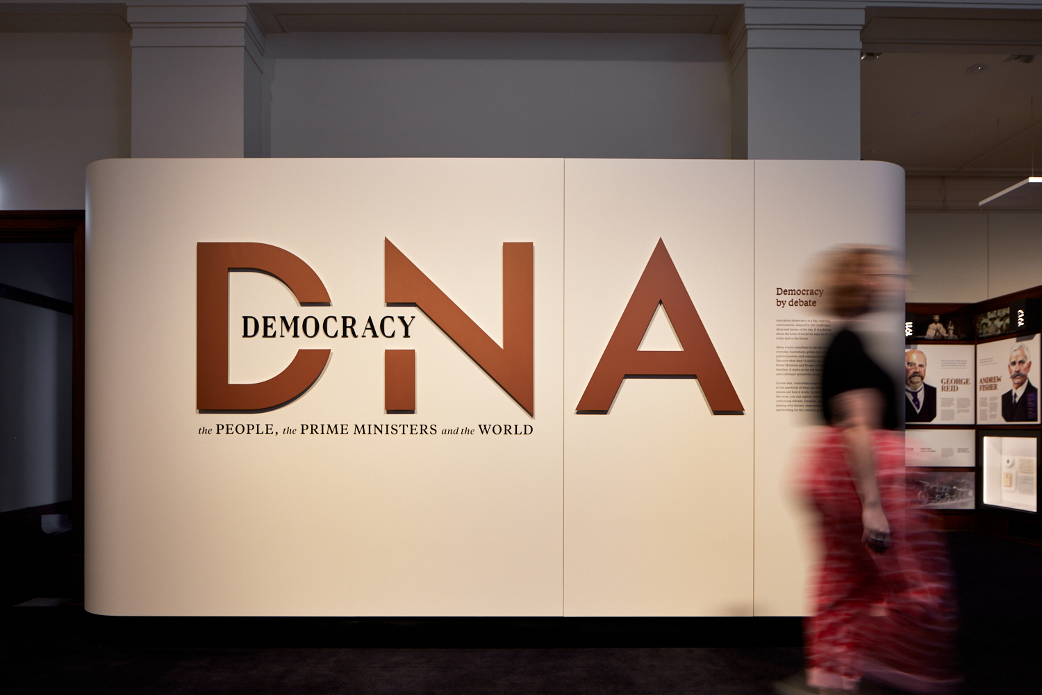 Wall that contains the exhibition's title 'Democracy DNA: the People, the Prime Ministers and the world.' Wall that contains the exhibition's title 'Democracy DNA: the People, the Prime Ministers and the world.'
