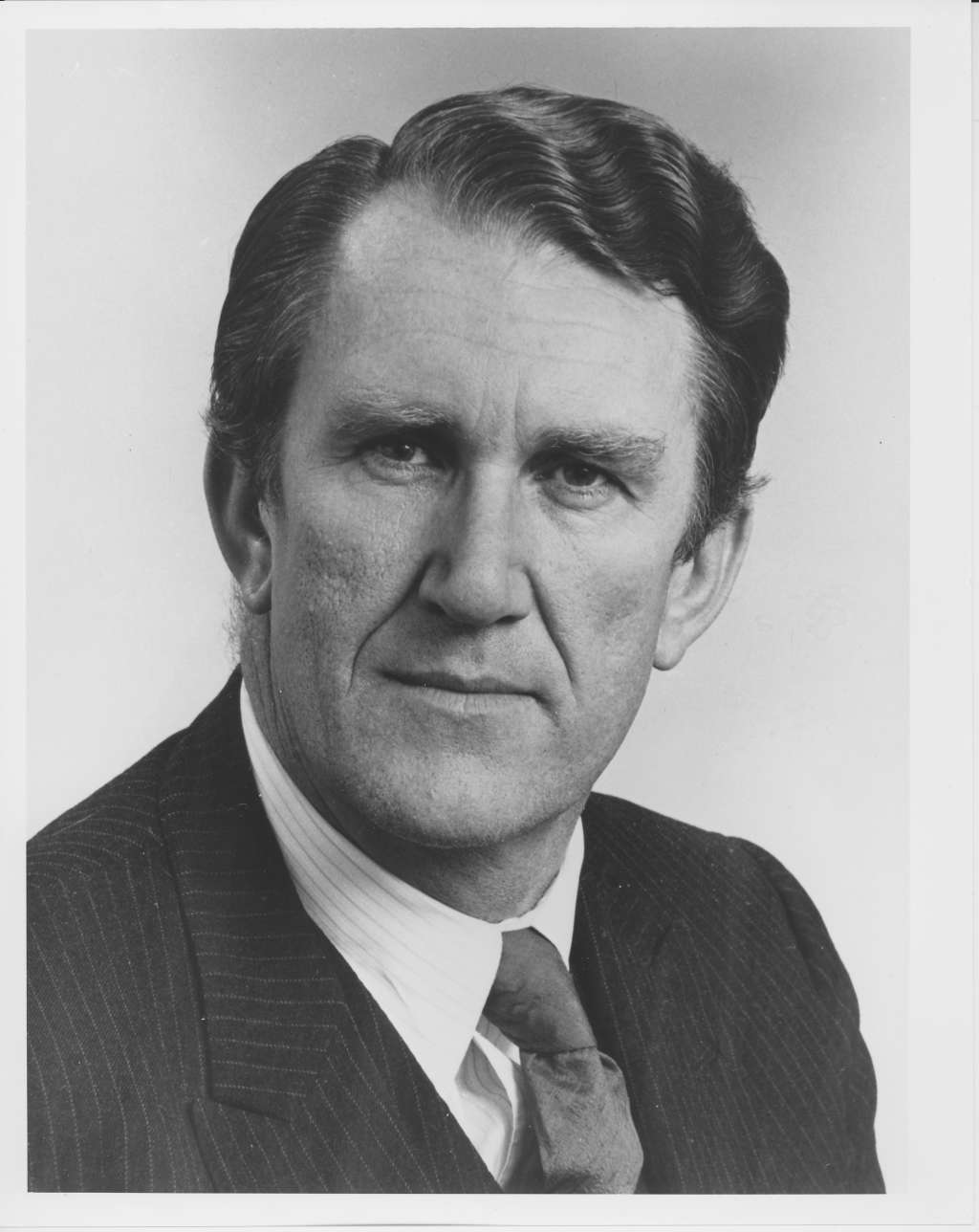 A man, Malcolm Fraser, wearing a pinstripe suit. A man, Malcolm Fraser, wearing a pinstripe suit.