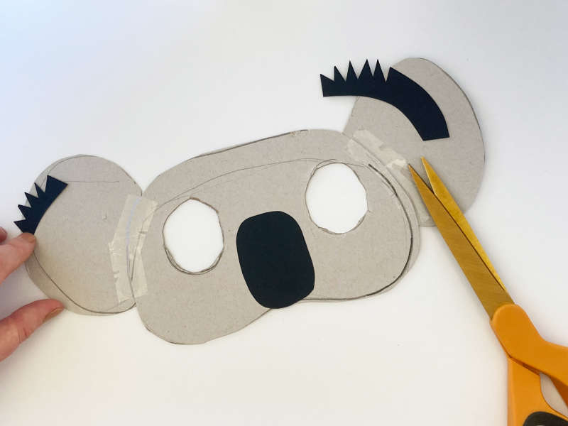 A koala mask with two eyes cut out, a black nose and black hair on the ears. A koala mask with two eyes cut out, a black nose and black hair on the ears.