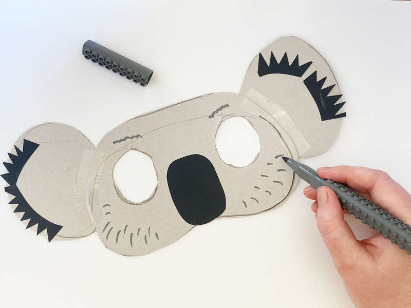 A koala mask with eyes cut out, black nose, black ears. A koala mask with eyes cut out, black nose, black ears.
