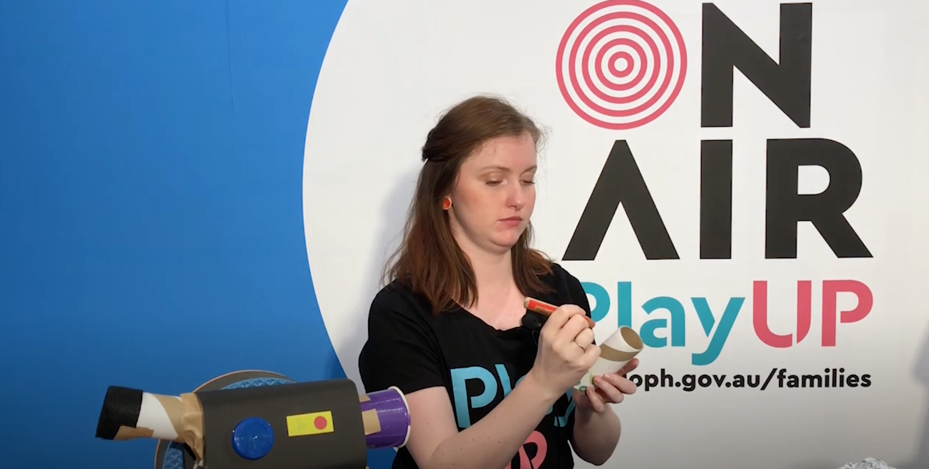 A PlayUp facilitator uses a texta on a piece of paper. A PlayUp facilitator uses a texta on a piece of paper.