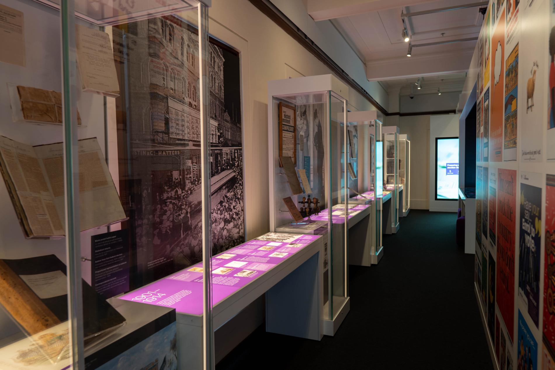 An exhibition space with glass showcases filled with objects An exhibition space with glass showcases filled with objects