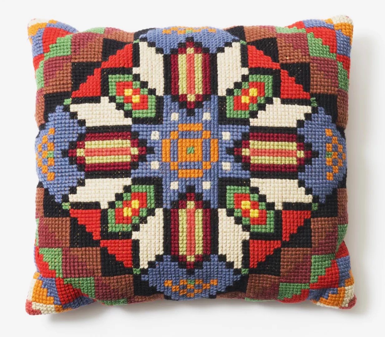 A hand-crafted cushion given to Calwell by members of the Ukrainian community. An embroidered multicoloured knitted cushion.
