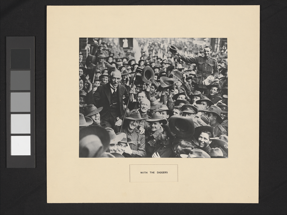 Prime Minister Hughes being held up by a crowd of returning soldiers in a busy street. Prime Minister Hughes being held up by a crowd of returning soldiers in a busy street.