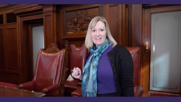  A women stands in the Senate Chamber of Old Parliament house.