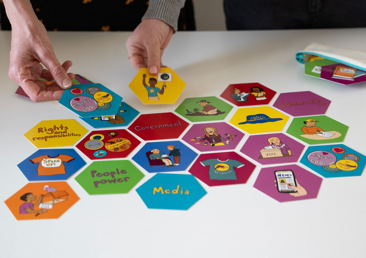 Hexagonal coloured squares with words about civic engagement.
