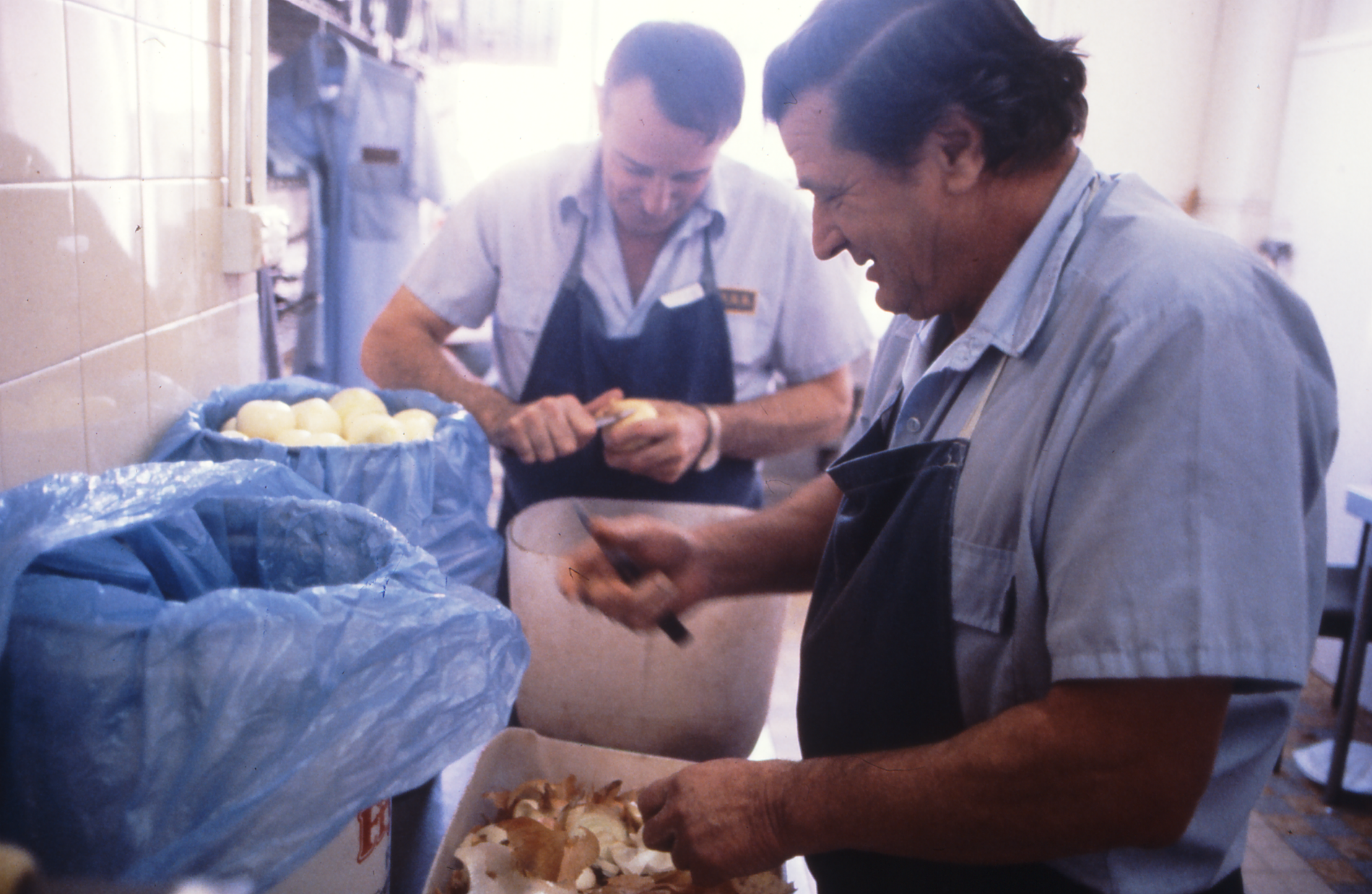 Kitchen staff preparing onions in Parliament House kitchen before its closure