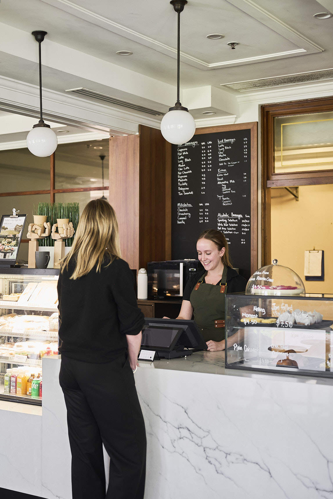 A customer placing an order with the barista at the cafe at the Museum of Australian Democracy.