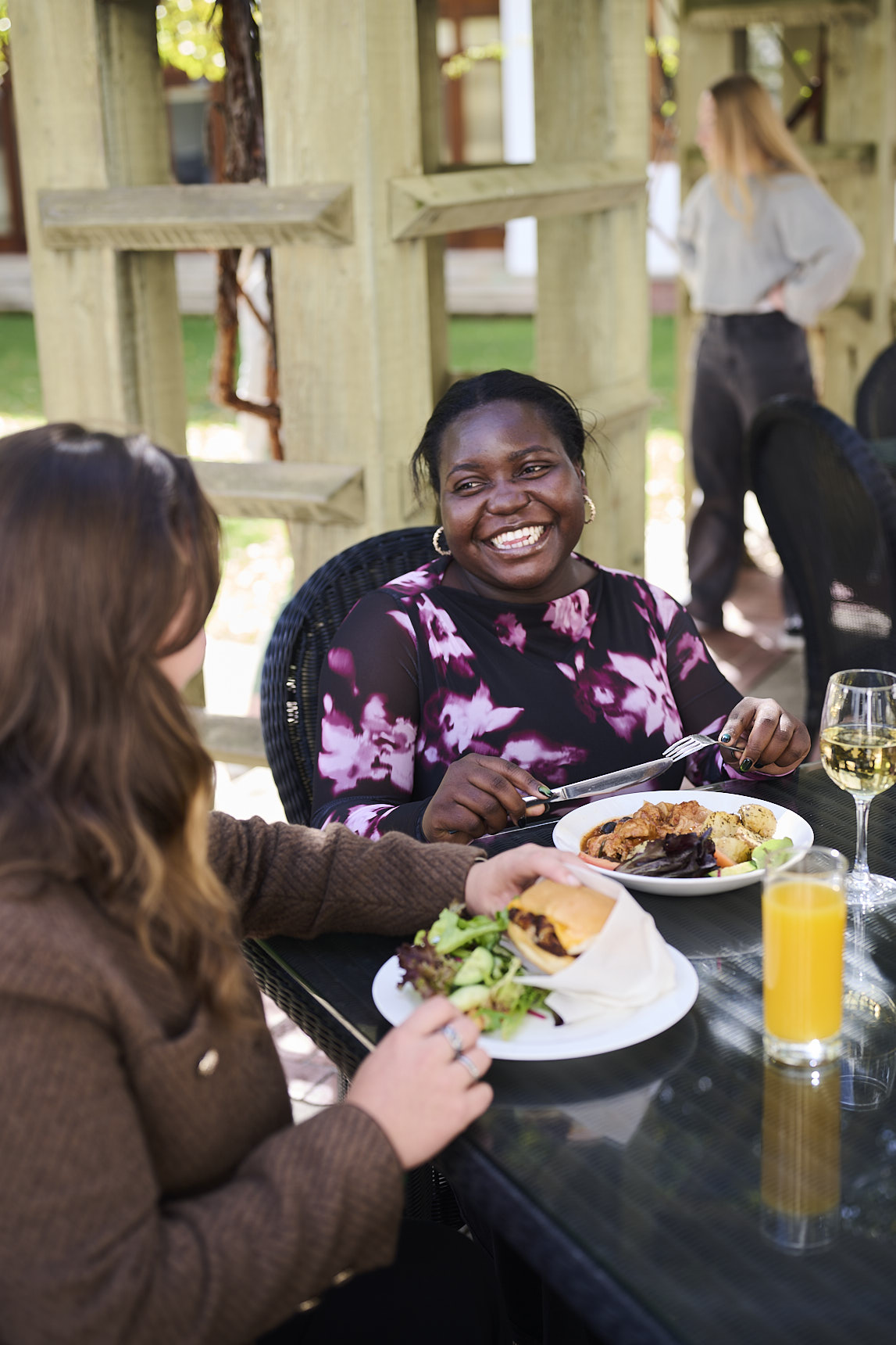 A couple customers enjoying a meal in the outdoor area of the cafe at the Museum of Australian Democracy.