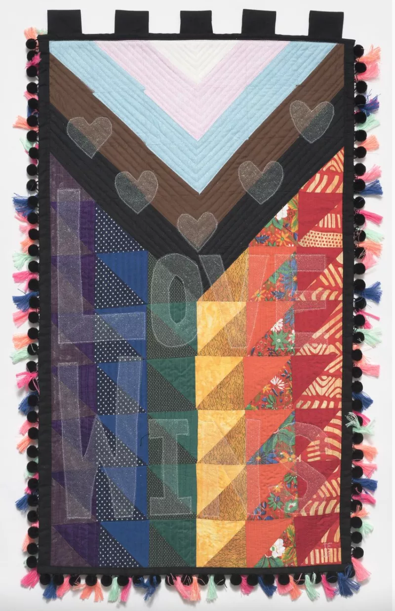 Multi-cultured rainbow tapestry containing the words 'Love wins'. Multi-cultured rainbow tapestry containing the words 'Love wins'.