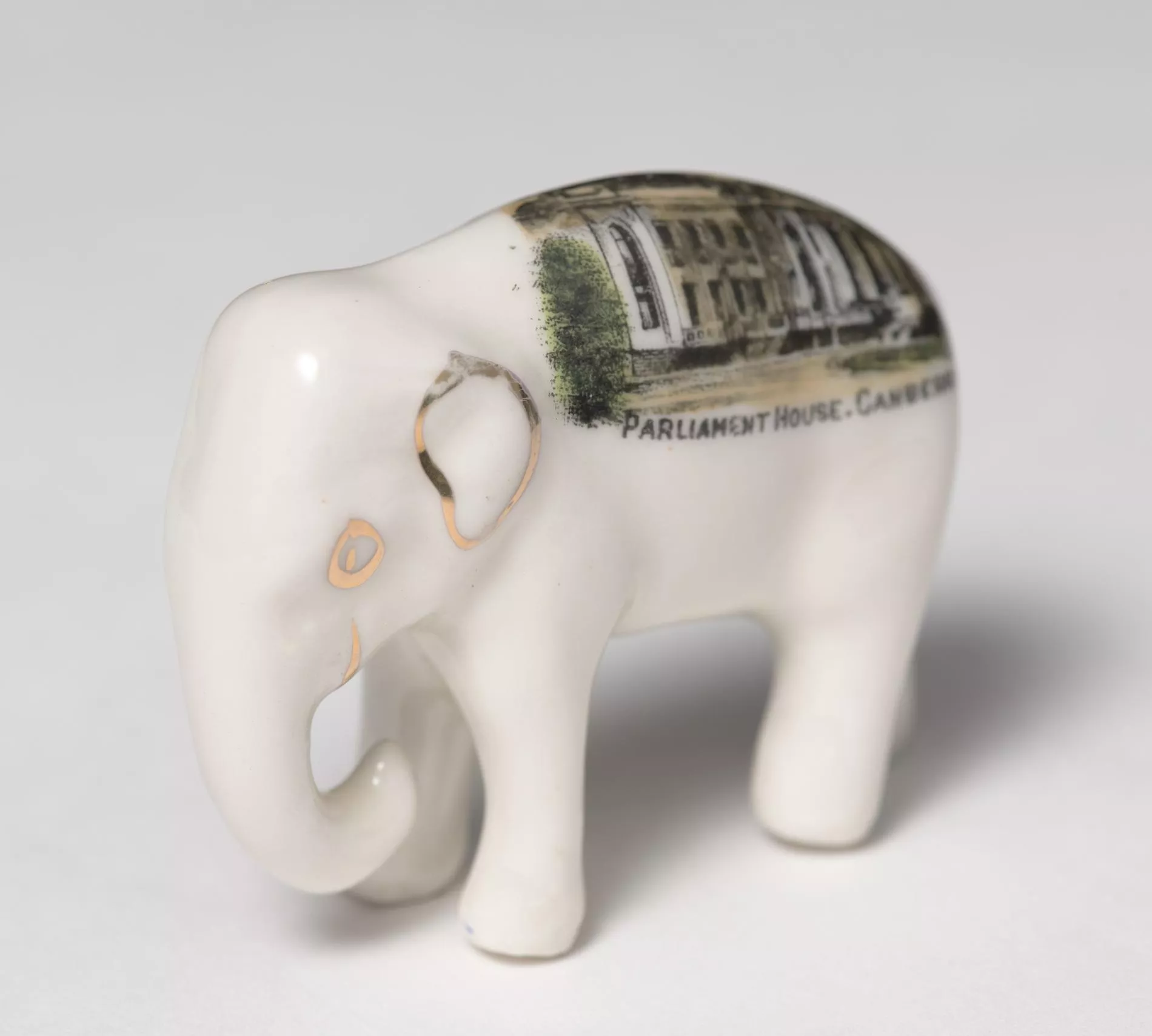 Photograph of a small, white ceramic elephant Photograph of a small, white ceramic elephant