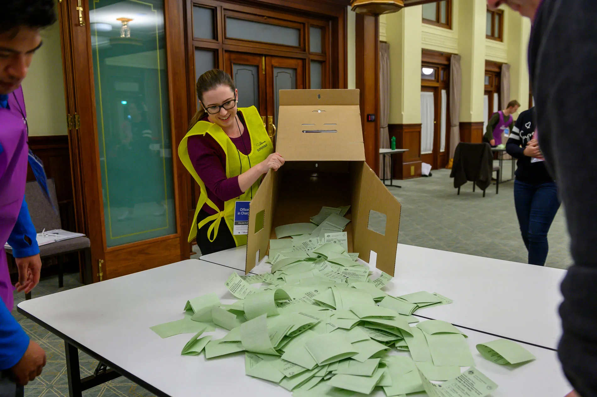 An AEC officer empties green ballot papers out of a ballot box in Old Parliament House. An AEC officer empties green ballot papers out of a ballot box in Old Parliament House.
