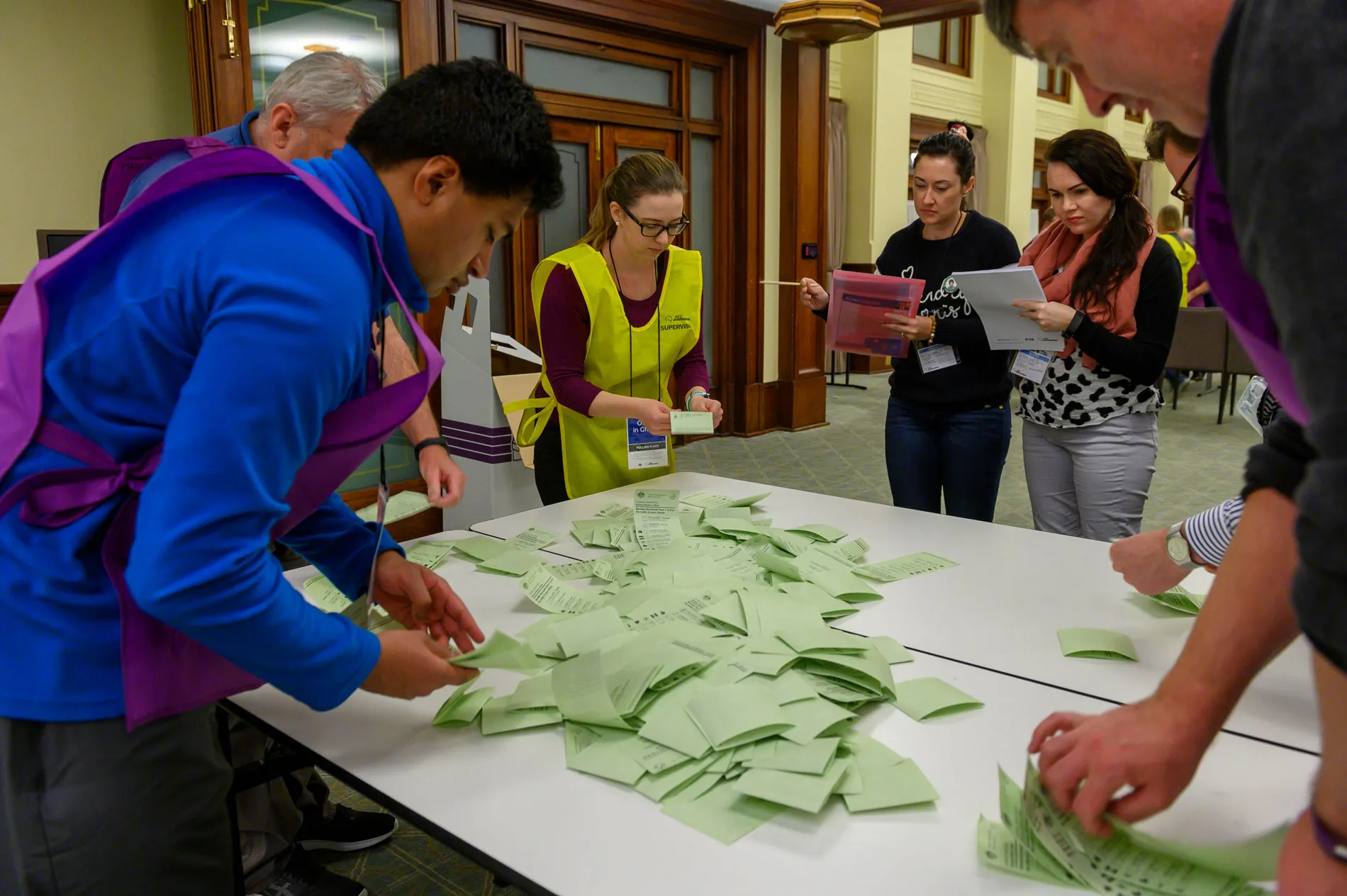 AEC staff count green ballot papers watched by scrutineers at Old Parliament House. AEC staff count green ballot papers watched by scrutineers at Old Parliament House.