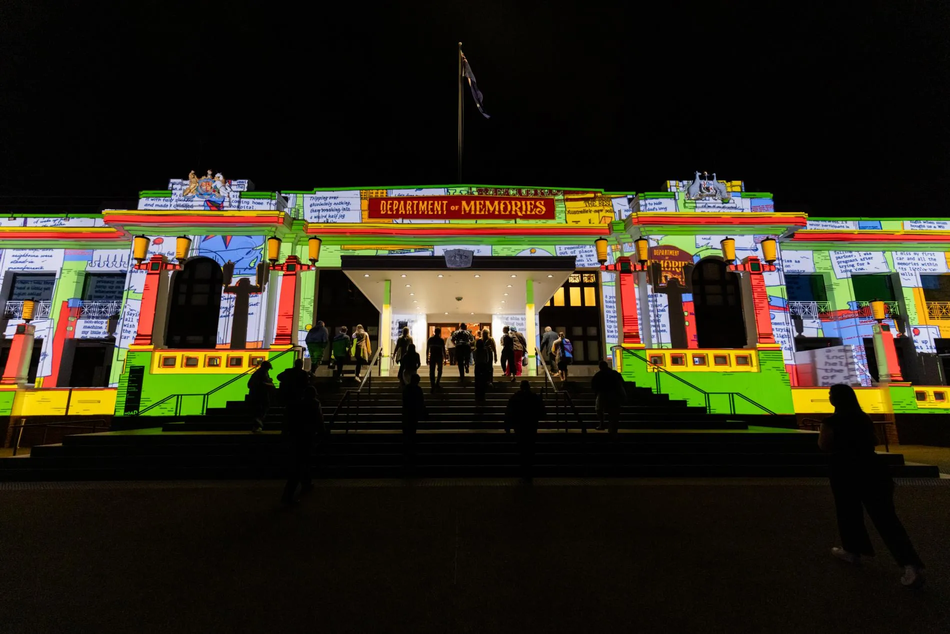 The front of Old Parliament House lit up for Enlighten 2026, above the entry a graphic says 'Department of Memories'.