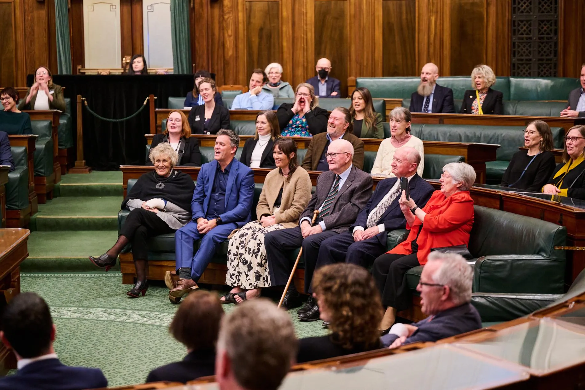 A group of people sitting in the House of Representatives Chamber reopening at Old Parliament House in 2024.