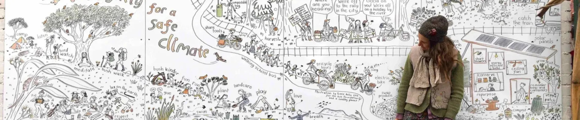 Trace Balla standing in front of a large mural illustration showing people living in nature. The mural is titled 'Live lightly for a safe climate'.