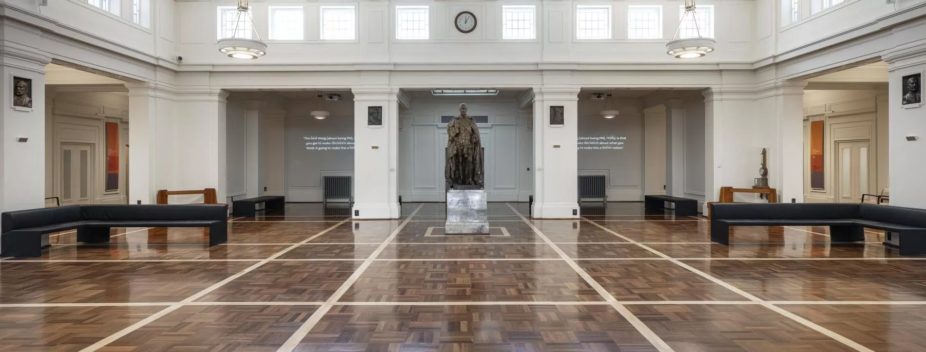 Kings Hall: a parquetry floor greets visitors, as they walk in to the spacious hall with the statue of King George V the main focal point. On either side of the statue sit two right-angled black leather seats for visitors to sit and take in the architectural details, including the pendant lights, clerestory windows and detailed geometric ceiling.