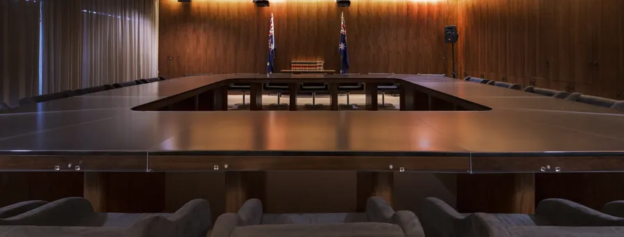 The Cabinet Room at Old Parliament House featuring a large table with chairs. The room is wood panelled.