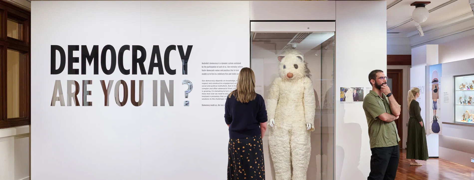 People view the Democracy Are You In exhibition featuring a giant possum costume in Old Parliament House.