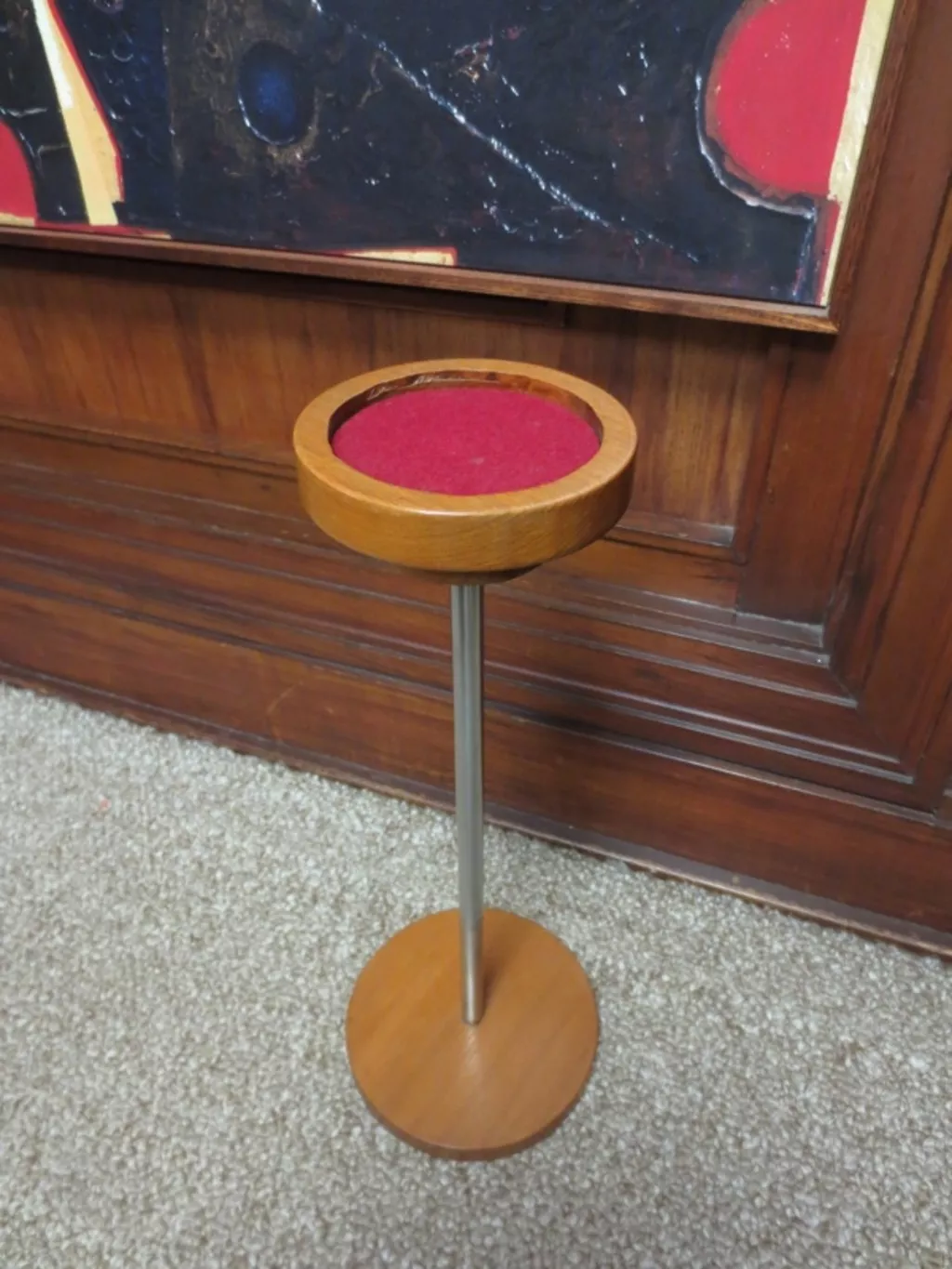 Wooden smokers stand for placing ashtrays on. A round wooden stand with a metal pole with wooden base.