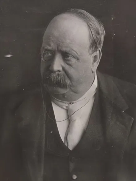 A man with a bushy moustache and a monocle, George Reid. A man with a bushy moustache and a monocle, George Reid.