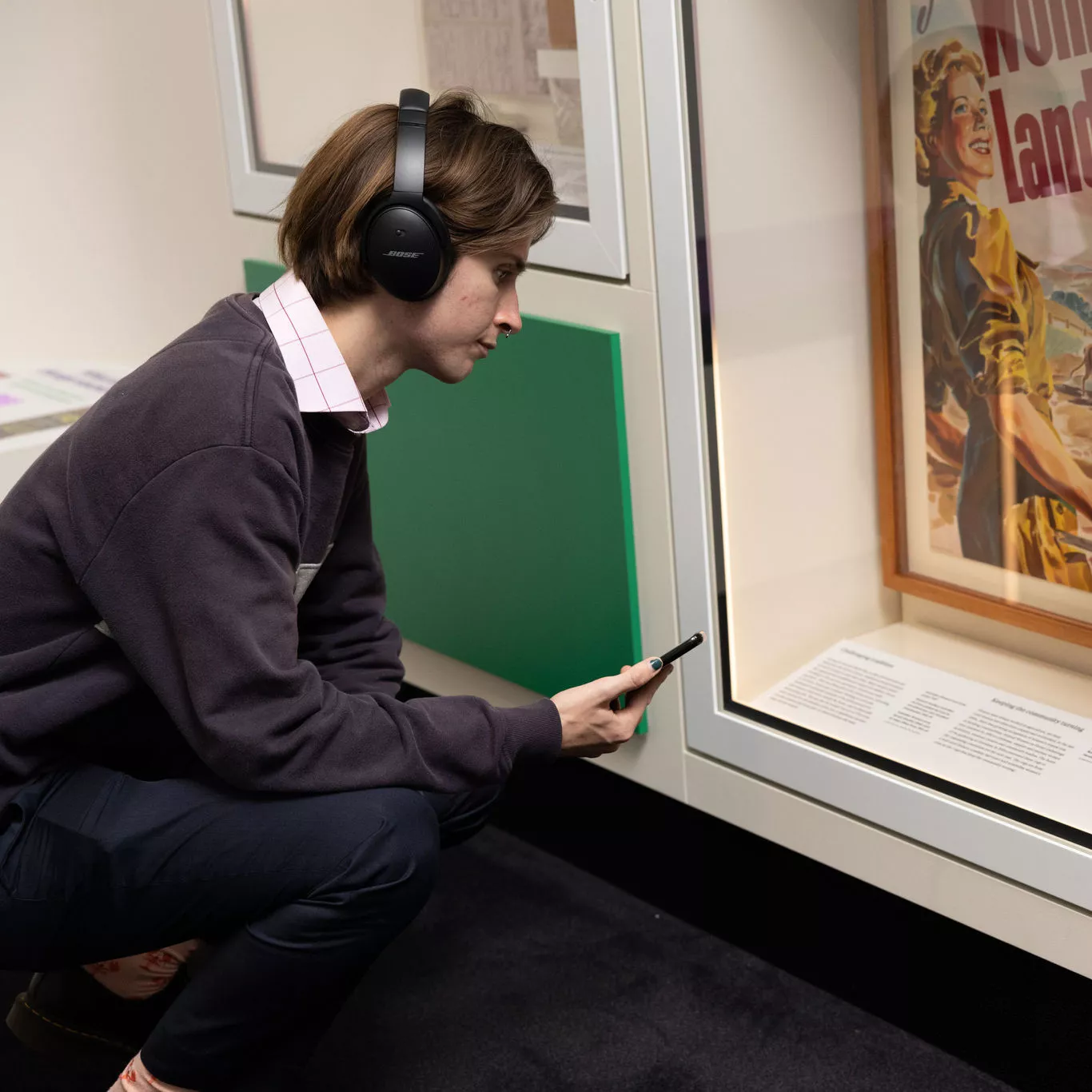 A visitor reading the information under one display