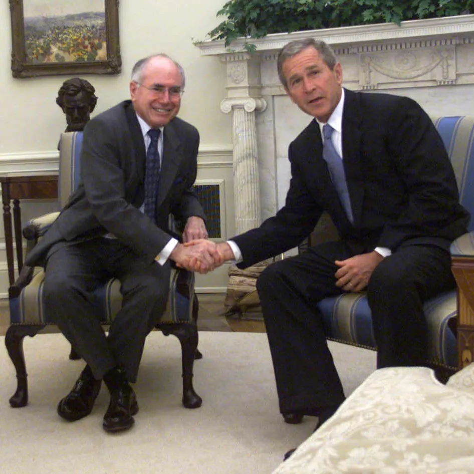 The relationship between John Howard and George W Bush was heavily scrutinised and criticised in the media and by Howard’s detractors. Howard saw it as key to a strong alliance between the two countries at a difficult time. Image: Fairfax Syndication John Howard and George W Bush are seated in two plush chairs in front of a fireplace, smiling and shaking hands.