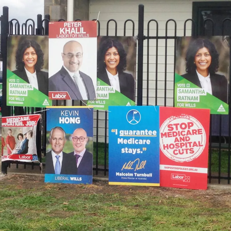 Election corflutes attached to a fence