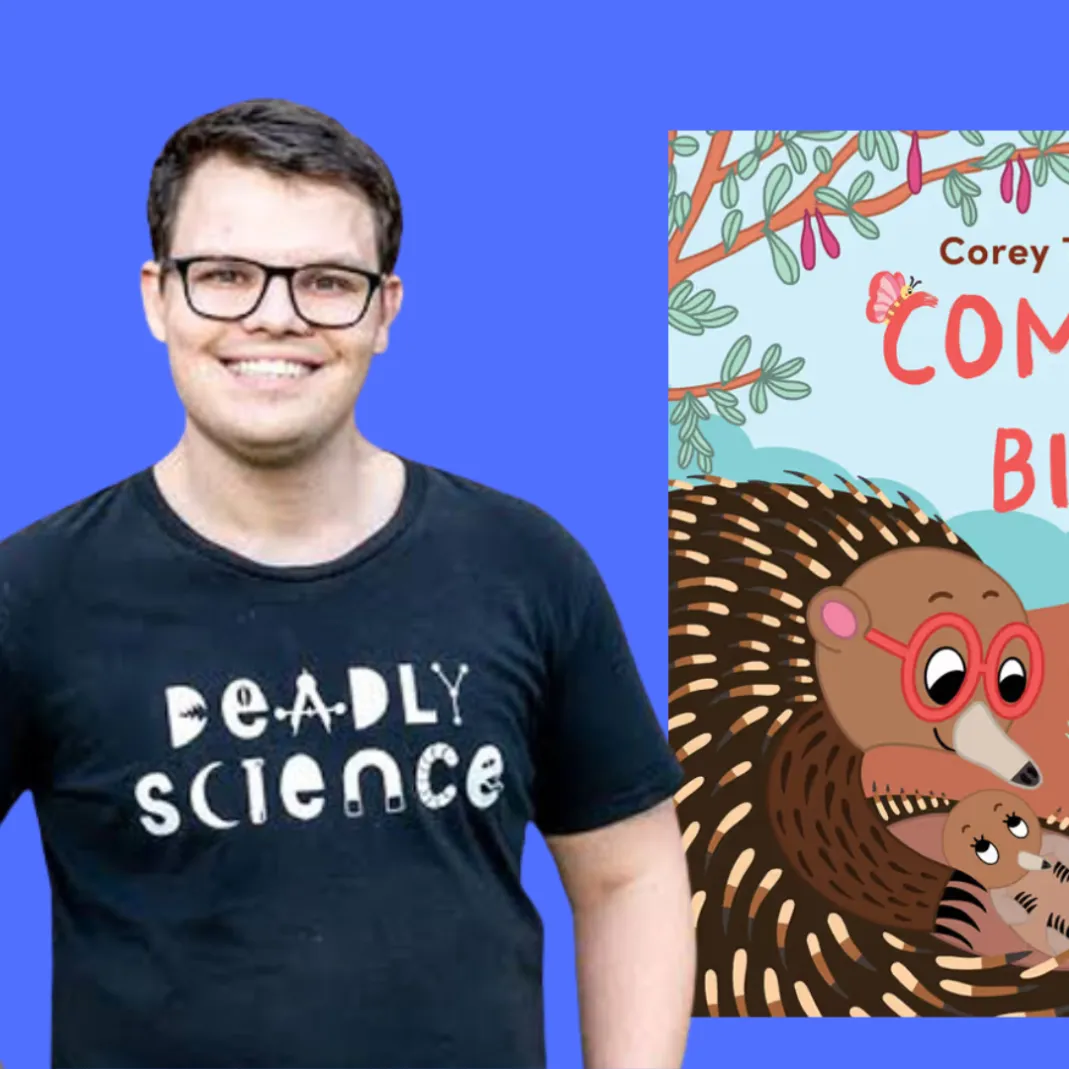 Corey Tutt standing near a render of his book 'Come Home, Bigibilia'