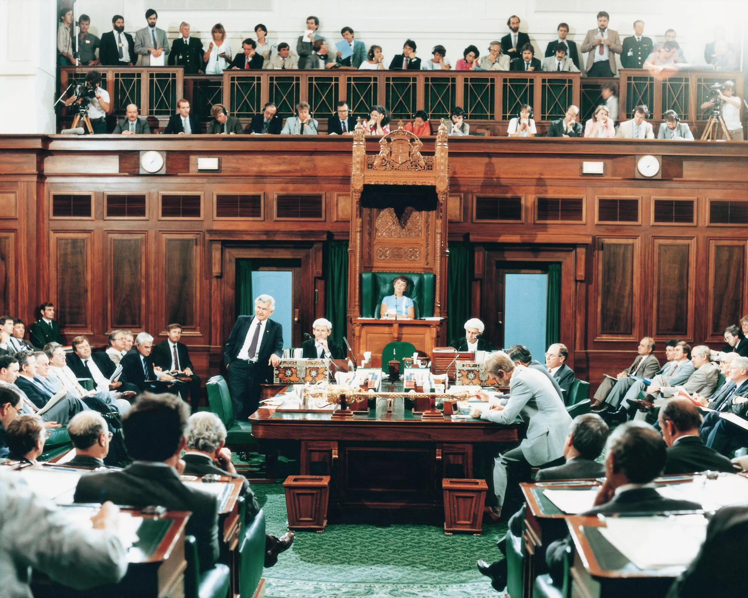 A view of the House of Reps Chamber and Press Gallery, filled with people.