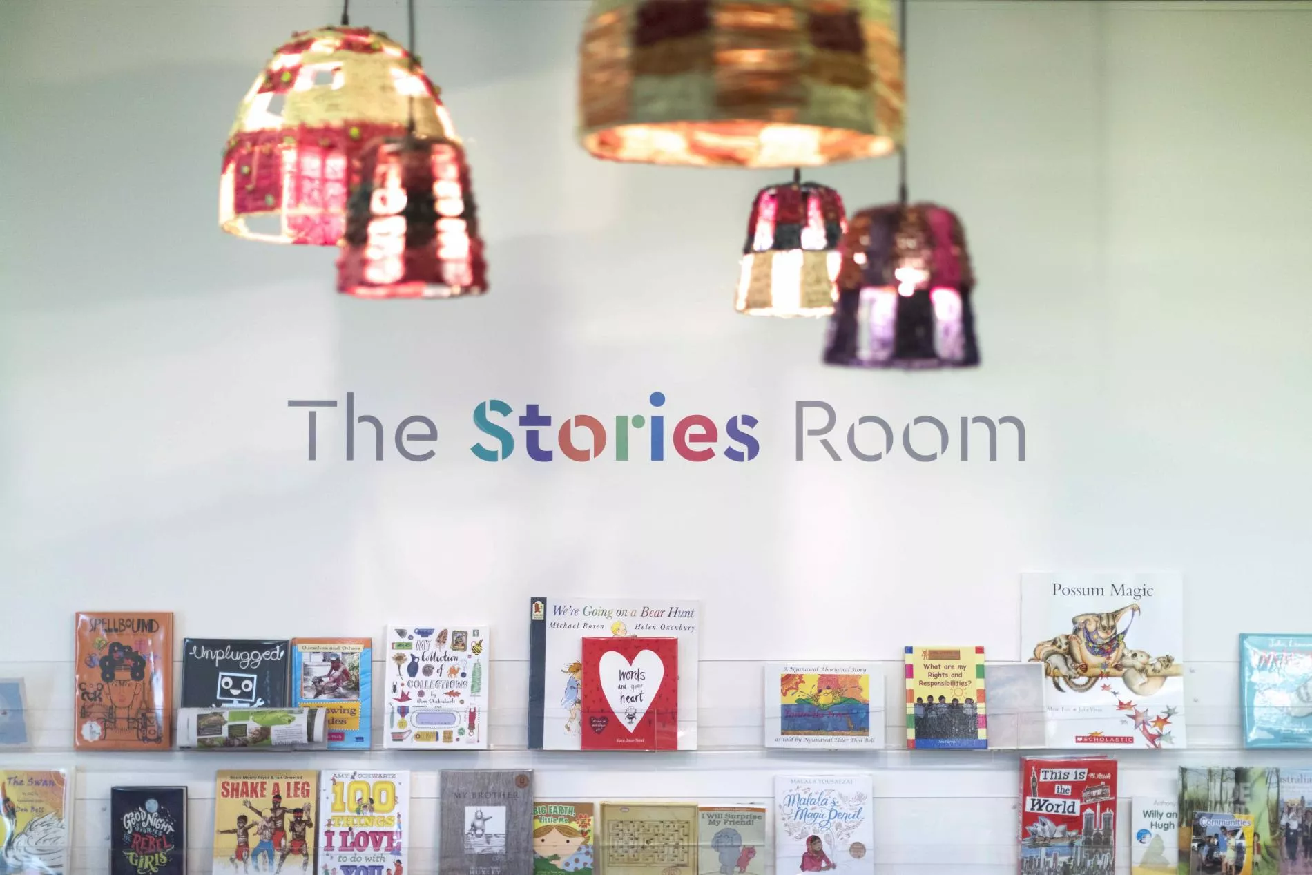 Picture books on a bookshelf with the words The Stories Room above. Picture books on a bookshelf with the words The Stories Room above.