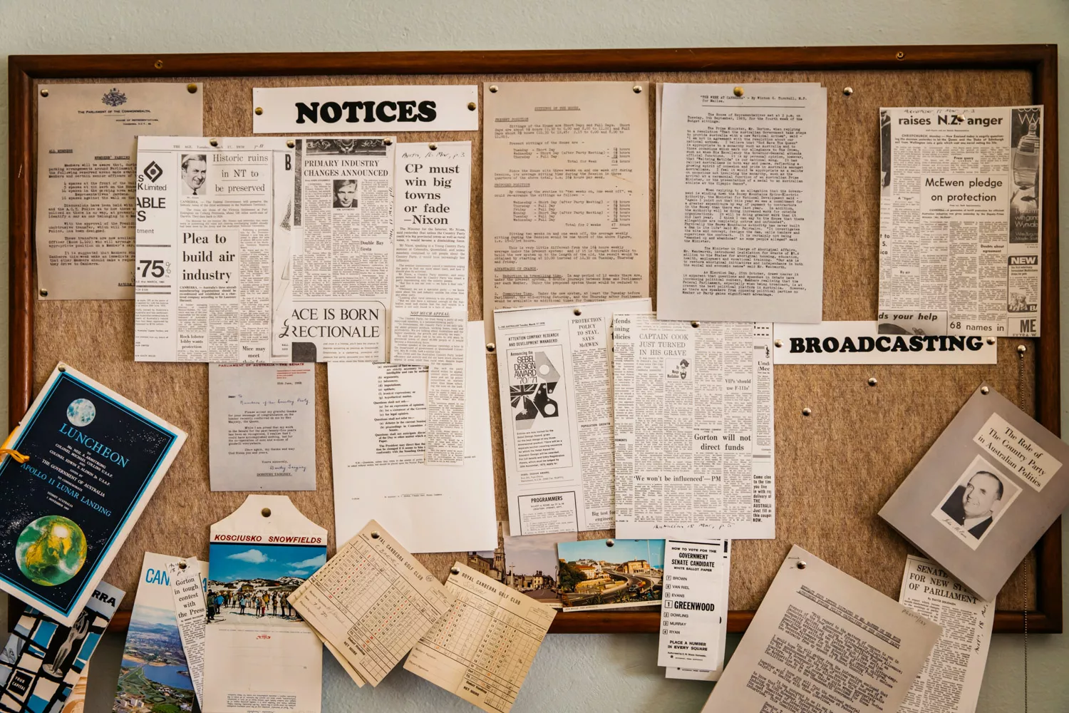 A pinboard covered with cutouts from newspapers from 1985, a postcard from the Kosciusko snowfields and a booklet with a black and white photo and the title 'the role of the Country Party in Australian politics.' A pinboard covered with cutouts from newspapers from 1985, a postcard from the Kosciusko snowfields and a booklet with a black and white photo and the title 'the role of the Country Party in Australian politics.'
