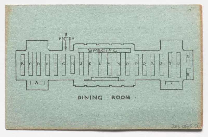 Photograph of a green ticket displaying an overlay of a dinining room with a table seating position. Photograph of a green ticket displaying an overlay of a dinining room with a table seating position.