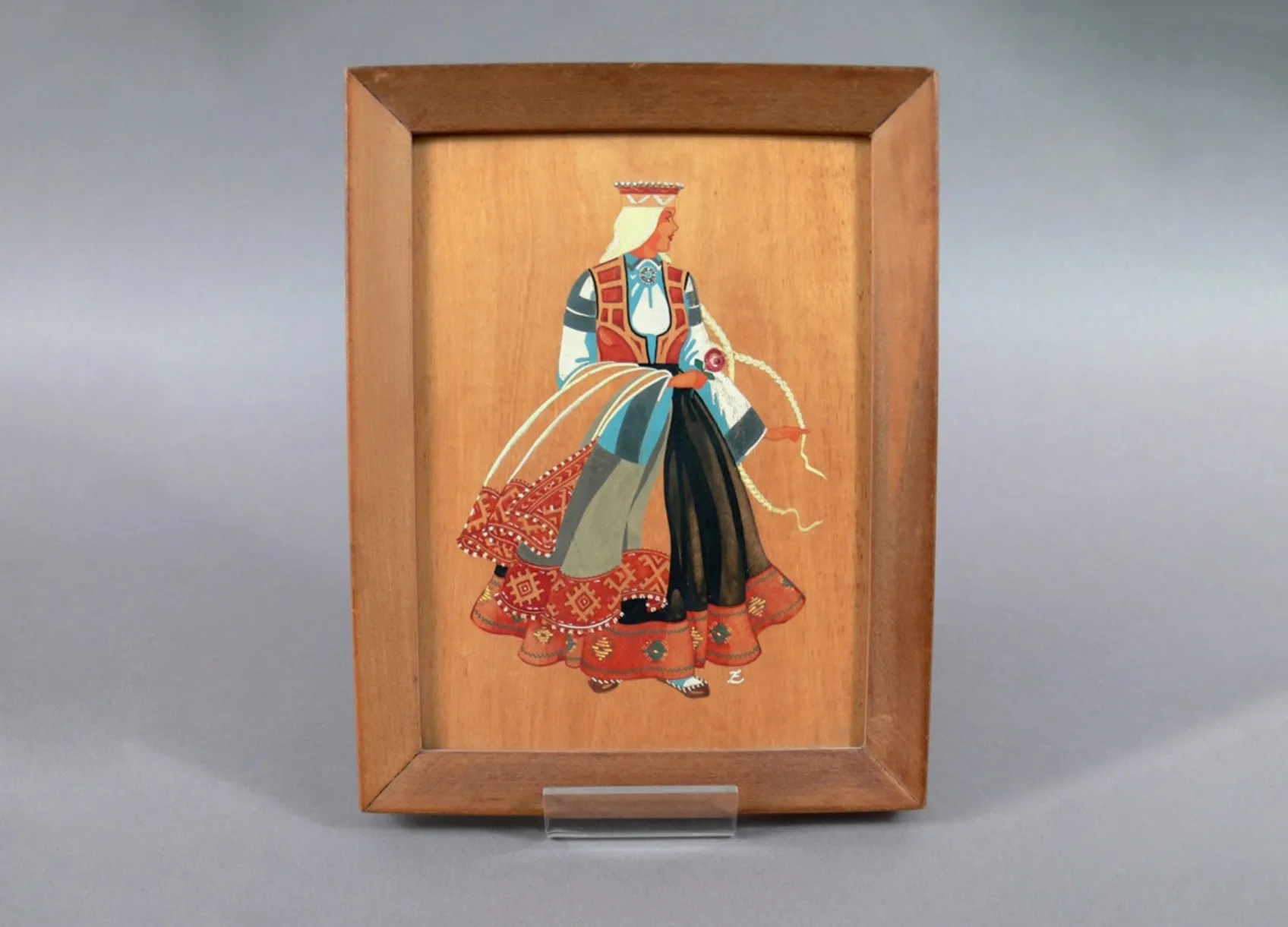 Painting on a wooden panel showing a woman wearing a traditional dress from Latvia. Painting on a wooden panel showing a woman wearing a traditional dress from Latvia.