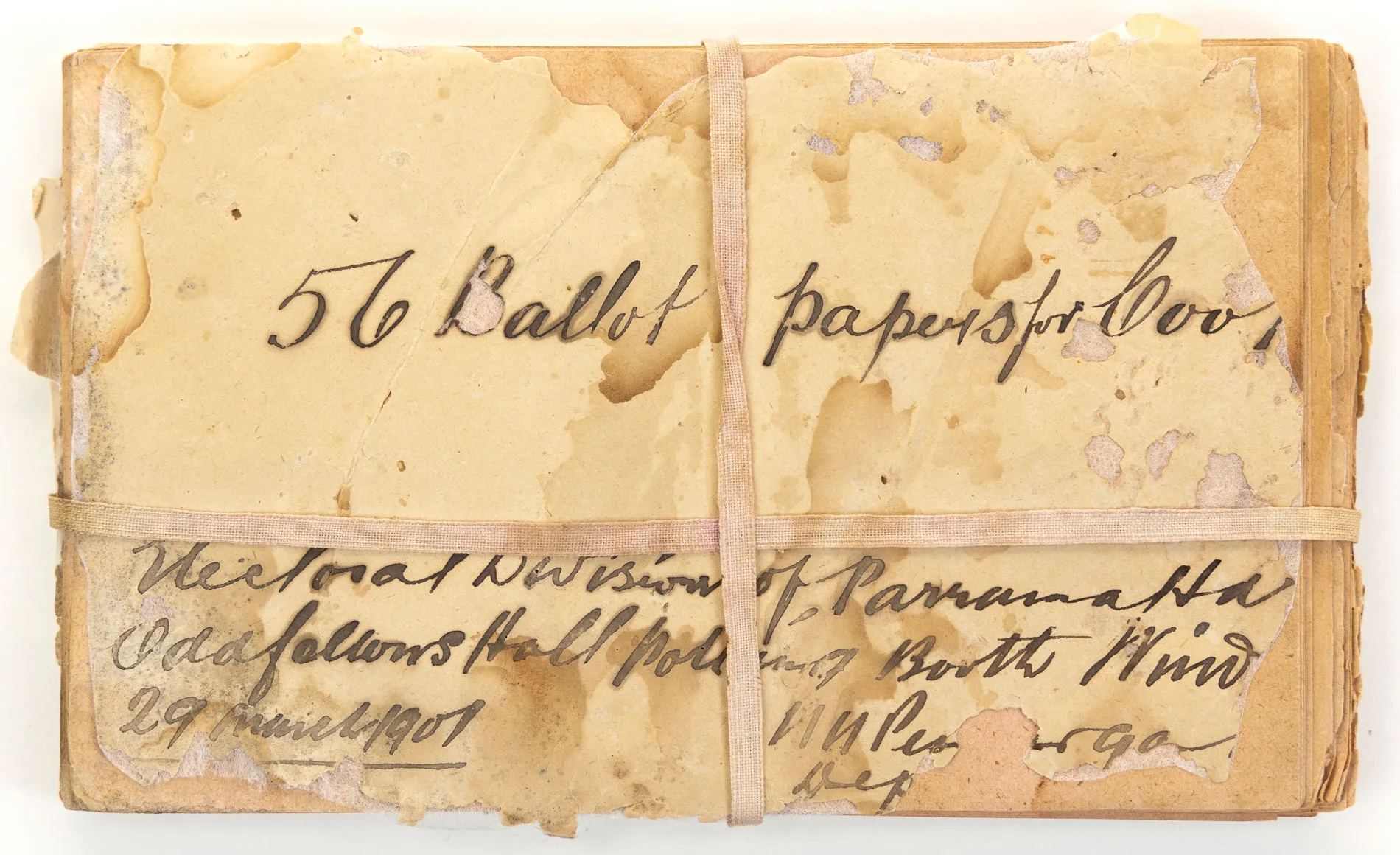 Aged yellow papers with calligraphy text including '56 Ballot papers' and '29 March 1901' are tied together with aged hessian ribbon. Aged yellow papers with calligraphy text including '56 Ballot papers' and '29 March 1901' are tied together with aged hessian ribbon.