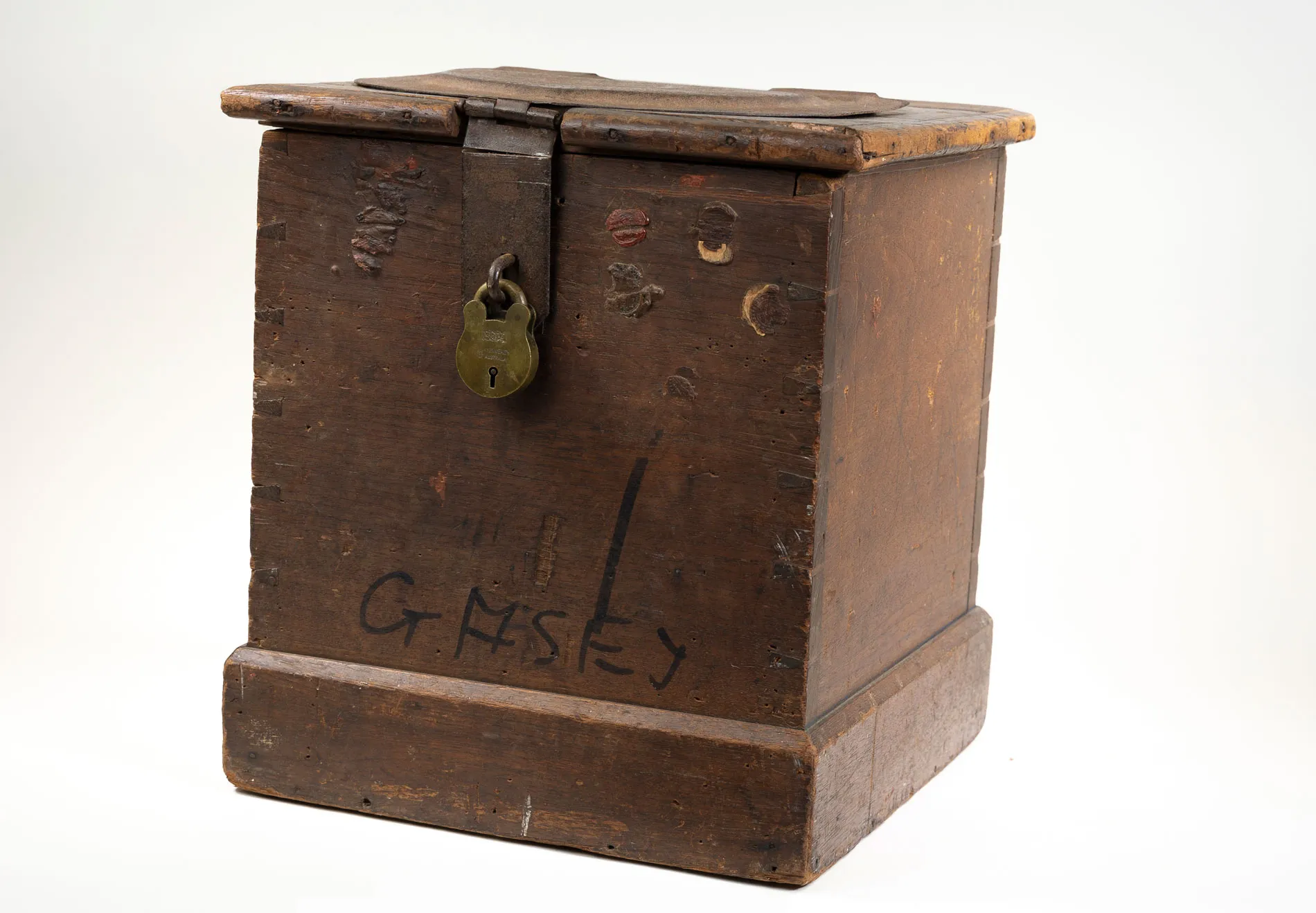 An old-fashioned wooden ballot box with a aged bronzed padlock on the front. An old-fashioned wooden ballot box with a aged bronzed padlock on the front.