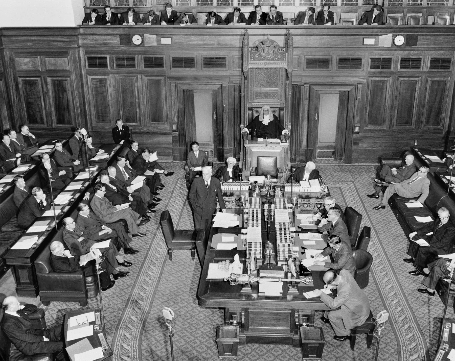 Parliamentarians sit in the House of Representatives at Old Parliament House in 1957. Sir Robert Menzies stands next to the centre table. Parliamentarians sit in the House of Representatives at Old Parliament House in 1957. Sir Robert Menzies stands next to the centre table.