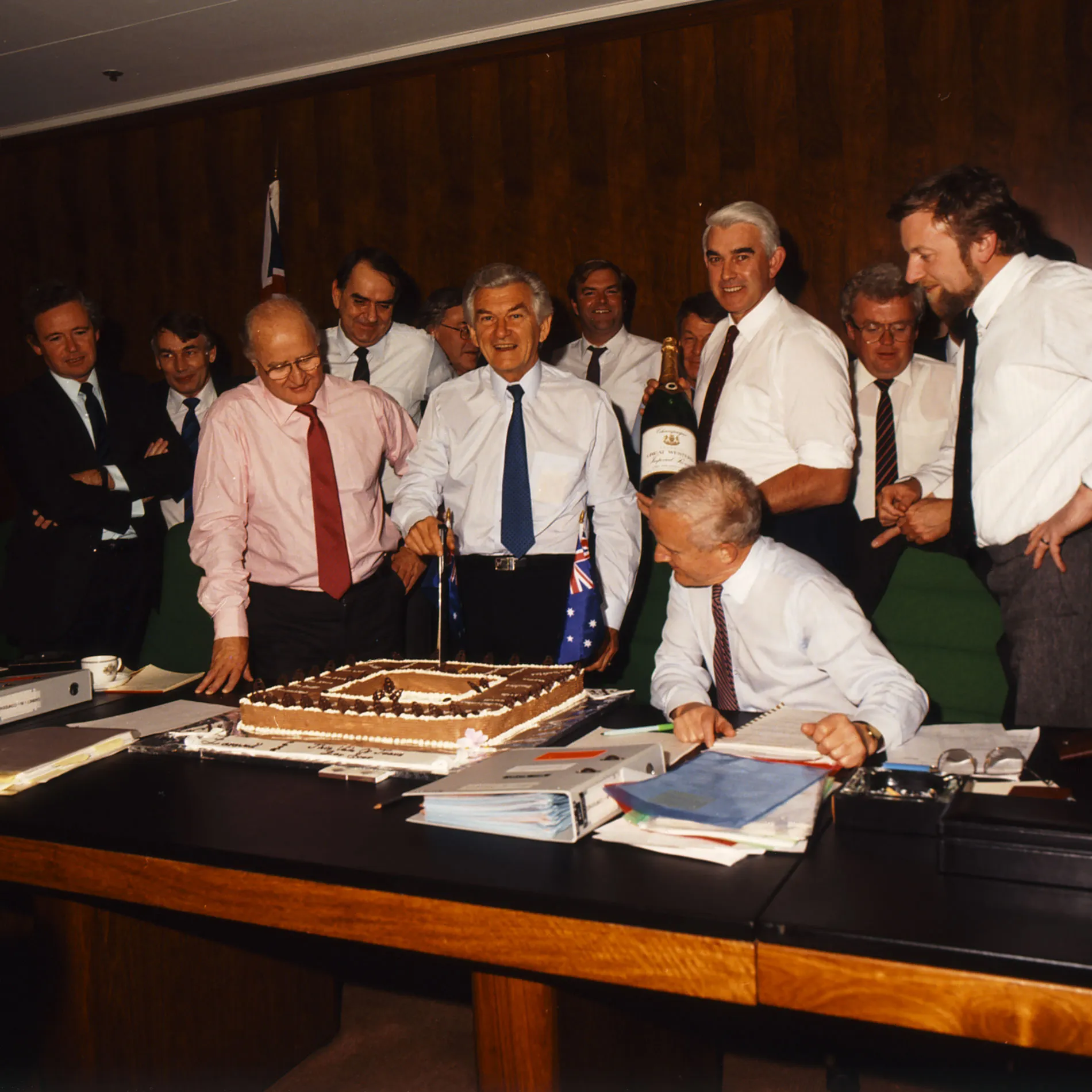 Bob Hawke cuts a cake in front of his members of Cabinet in the Cabinet Room at Old Parliament House.